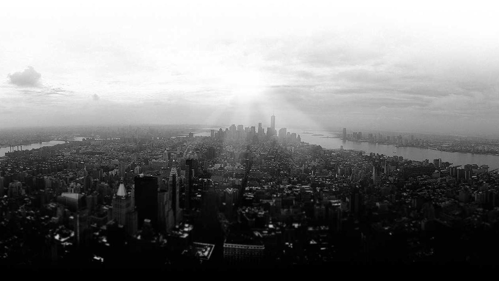 Dense city rooftops seen from above at first light